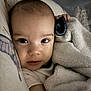 baby, blanket, closeup, face, infant, sleeping_area, soft_texture, cushion, cozy, indoors, child, portrait, warm, comfort, young, skin, expression, resting, wrapped, cute