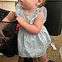 Evelynn is registered to the contest to win money with this photo: basket, blue_dress, cardboard_box, carpet, child, clothing, earrings, exploring, fabric, face, floor, hand, home, indoor, legs, person, pony_tail, shoes, toddler, toy
