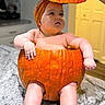 baby, pumpkin, baby_in_pumpkin, kitchen, orange, cute, child, infant, costume, holiday, autumn, portrait, indoor, table, marble_countertop, headwear, curious, chubby, skin, hand