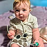 Niko is registered to the contest to win money with this photo: baby, child, infant, sitting, holding, brush, sunglasses, clothing, bed, indoors, curious, face, eyes, hair, cute, young, skin, hand, footwear, portrait