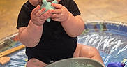 Niko joined the competition — help win amazing prizes! baby, blue_toy, bowl, child, cute, face, floor, foam, hands, happy, indoor, play, playtime, sitting, skin, slime, smile, socks, toy, water