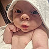 baby, infant, towel, hood, skin, face, arm, hand, expression, cute, newborn, portrait, indoors, soft_texture, closeup, child, person, resting, curious, pout