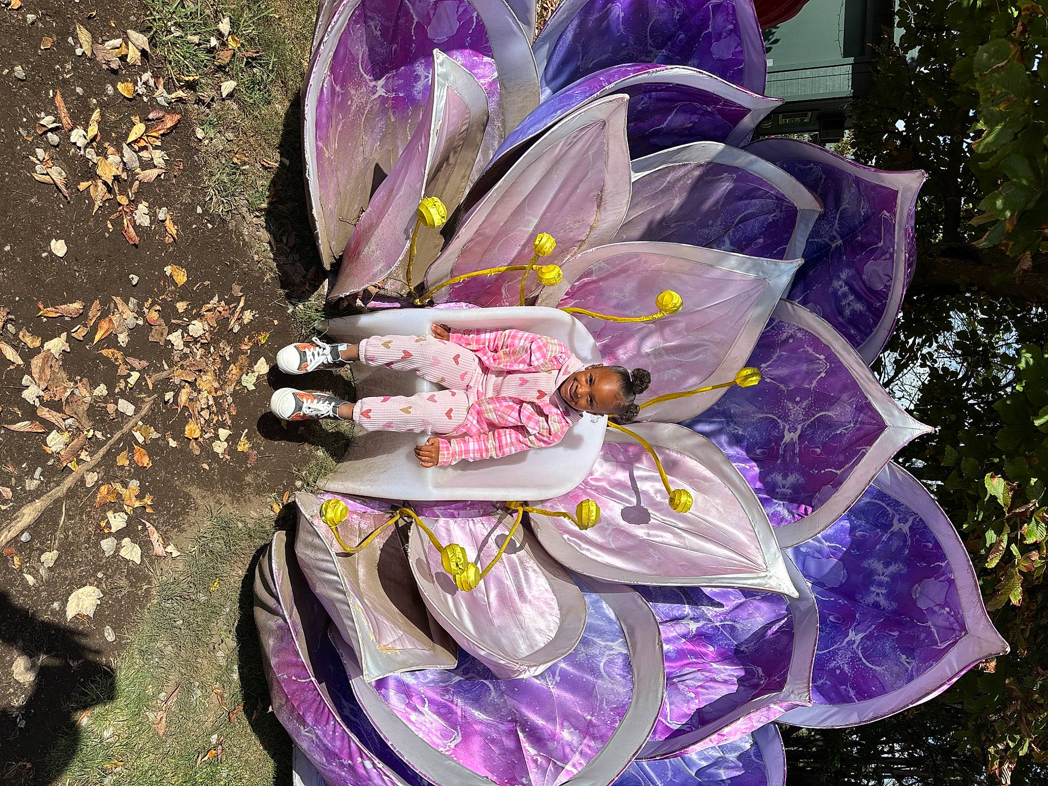 Nadia Hayes Rana is registered to the contest to win money with this photo: art, automotive_wheel_system, botany, event, flower, flowering_plant, illustration, joy, lawn_ornament, magenta, organism, painting, person, petal, plant, plant_stem, pole, purple, terrestrial_plant, tree