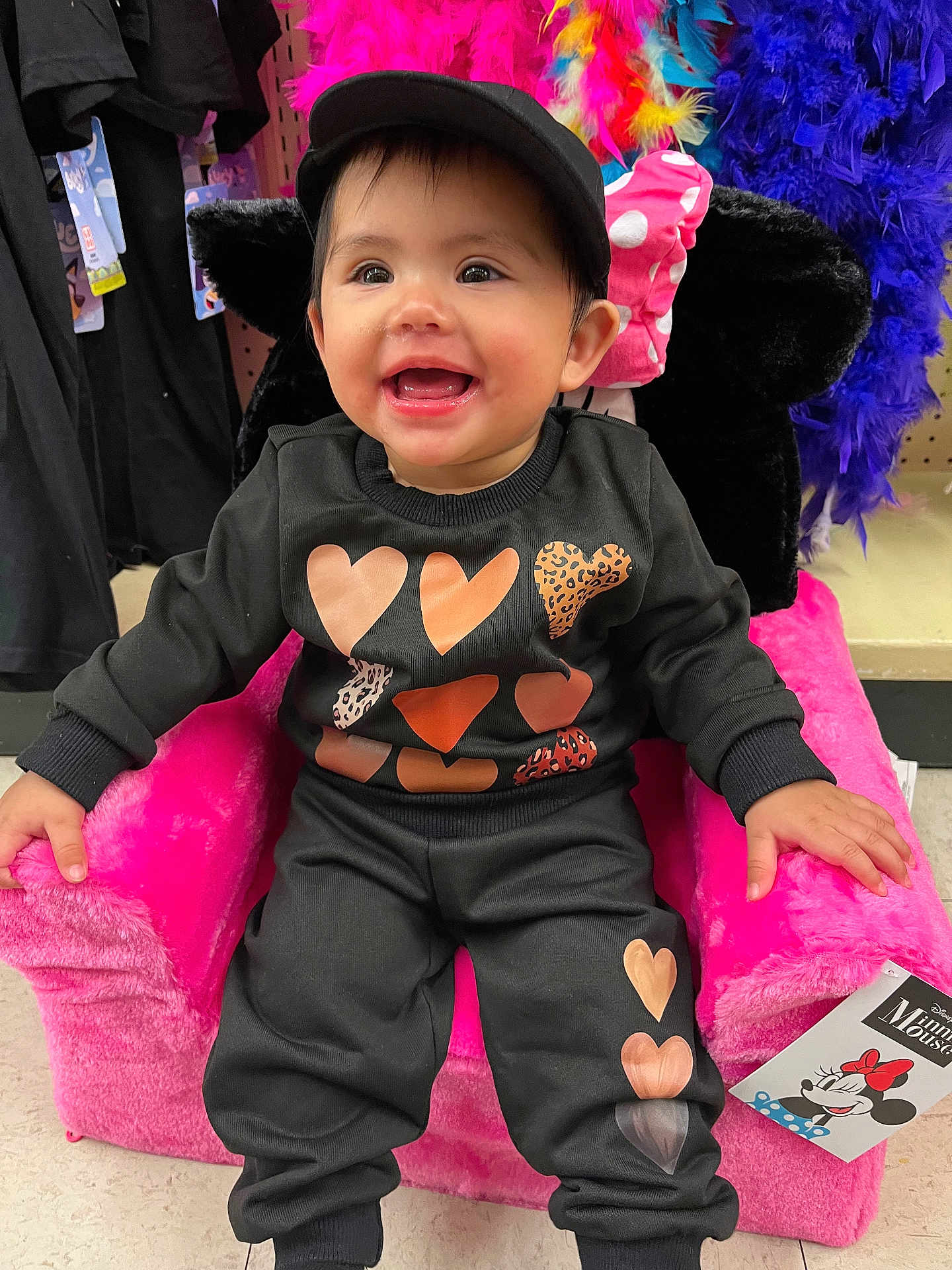 Kailany is registered to the contest to win money with this photo: accessories, baby, bodypart, cap, chair, clothing, costume, face, finger, furniture, hand, happy, hat, head, pants, person, photography, portrait, purple, smile