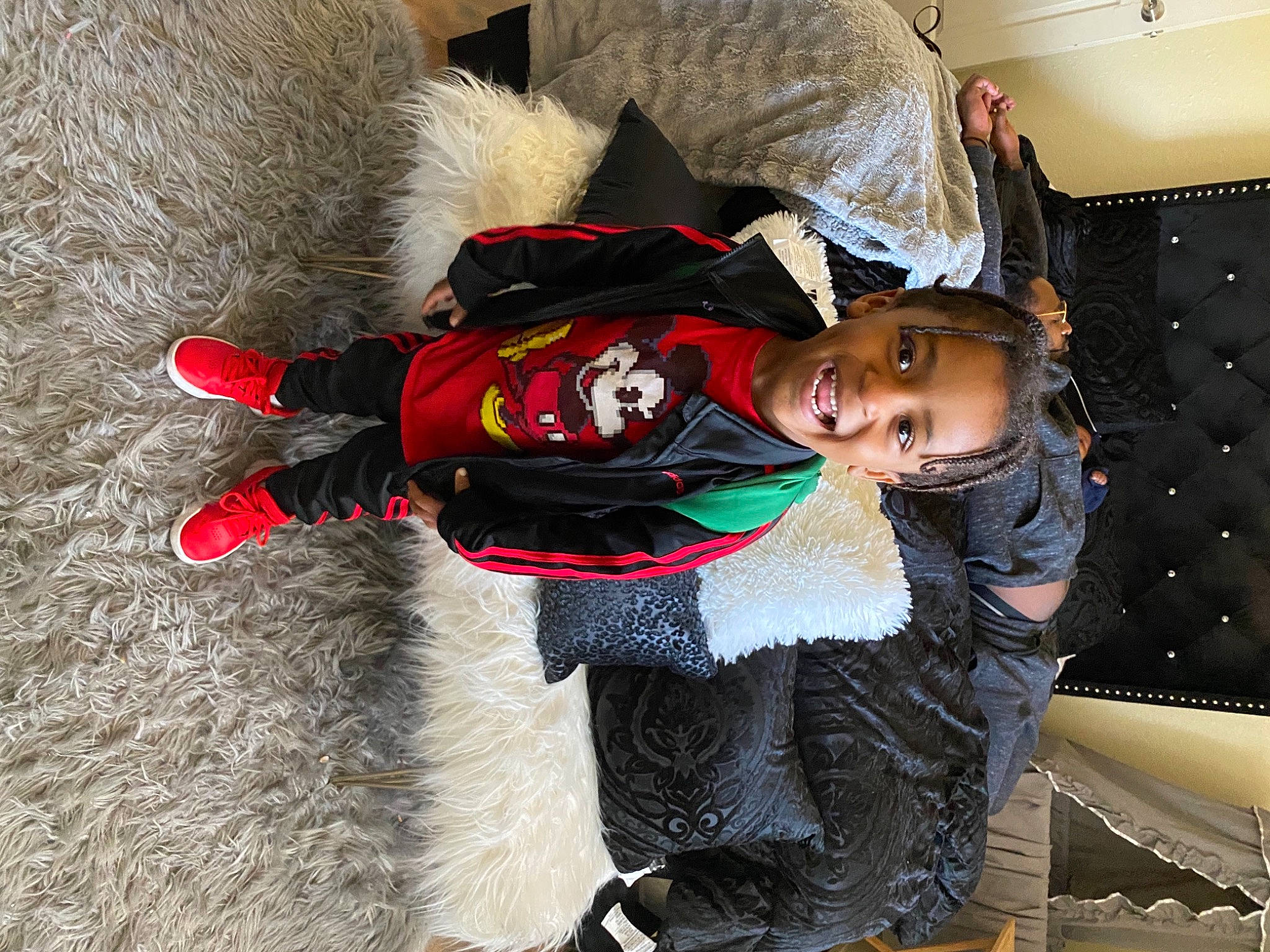 Jakai is registered to the contest to win money with this photo: carmine, child, comfort, costume, curtain, event, fashion_design, fun, fur, fur_clothing, glove, hat, joy, person, personal_protective_equipment, sitting, sleeve, street_fashion, toddler, tradition