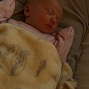 Scarlett is registered to the contest to win money with this photo: baby, sleeping, blanket, bed, soft, cozy, infant, child, pink_clothing, animal_print, peaceful, resting, portrait, indoors, cute, warm, comfort, face, head, young