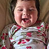 baby, smiling, laughing, child, face, cute, infant, clothing, onesie, pattern, cherry, happy, portrait, indoor, soft_lighting, person, young_child, closeup, head, rosy_cheeks