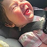 Zella is registered to the contest to win money with this photo: baby, car_seat, child, smiling, sunlight, seatbelt, happy, infant, safety, cute, cheeks, clothing, pink, striped, portrait, face, head, car_interior, seat, joyful