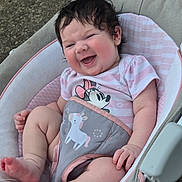 Zella is registered to the contest to win money with this photo: baby, infant, smiling, happy, cute, child, seat, baby_seat, clothing, striped_shirt, minnie_mouse, unicorn, blanket, pink, white, outdoor, grass, foot, hand, person