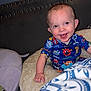 Asher is registered to the contest to win money with this photo: baby, infant, smiling, pajamas, pillow, bed, headboard, red_eye, ear, hand, blanket, indoor, flash, bedroom, happy, person, sitting, cute, nursery, patterned_clothing
