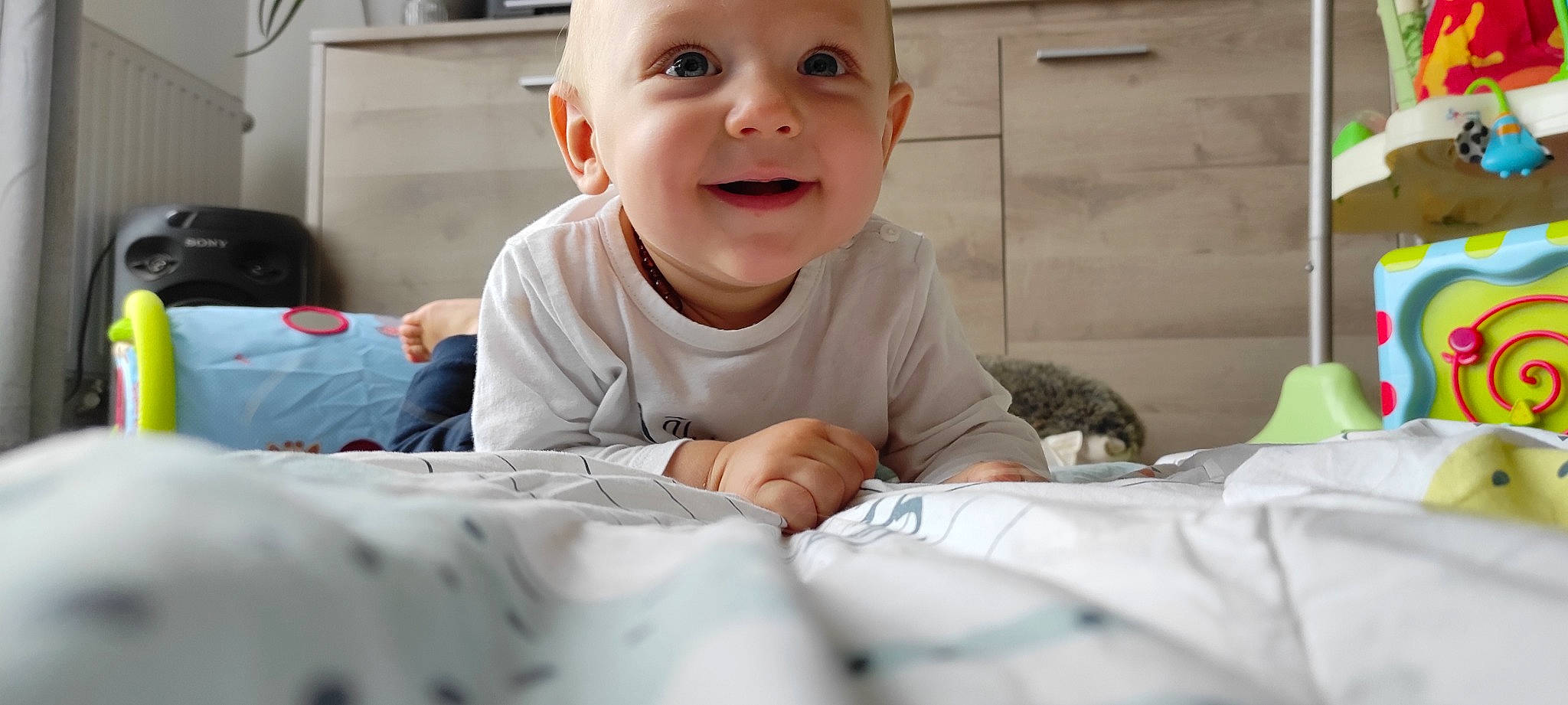 Milann a rejoint le concours — aidez-le/la à gagner de superbes lots ! baby, baby_toddler_clothing, cheek, child, comfort, face, fun, gesture, happy, head, iris, linens, mouth, nose, person, room, sitting, skin, sleeve, smile