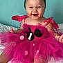 baby, child, tutu, pink, dress, bow, headband, smile, happy, sitting, bed, white_bed, polka_dots, tulle, cute, infant, portrait, indoor, person, wall