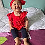 toddler, child, smiling, red_headband, red_top, black_leggings, barefoot, bed, blanket, indoor, happy, cute, portrait, sitting, young_child, headwear, playful, person, home, baby