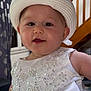 Leïya participe au concours pour gagner de l'argent avec cette photo : baby, child, white_dress, hat, indoor, portrait, smile, curtains, staircase, pearl_embellishment, sequins, chubby_cheeks, cute, person, face, headwear, elegant, closeup, young_child, happy