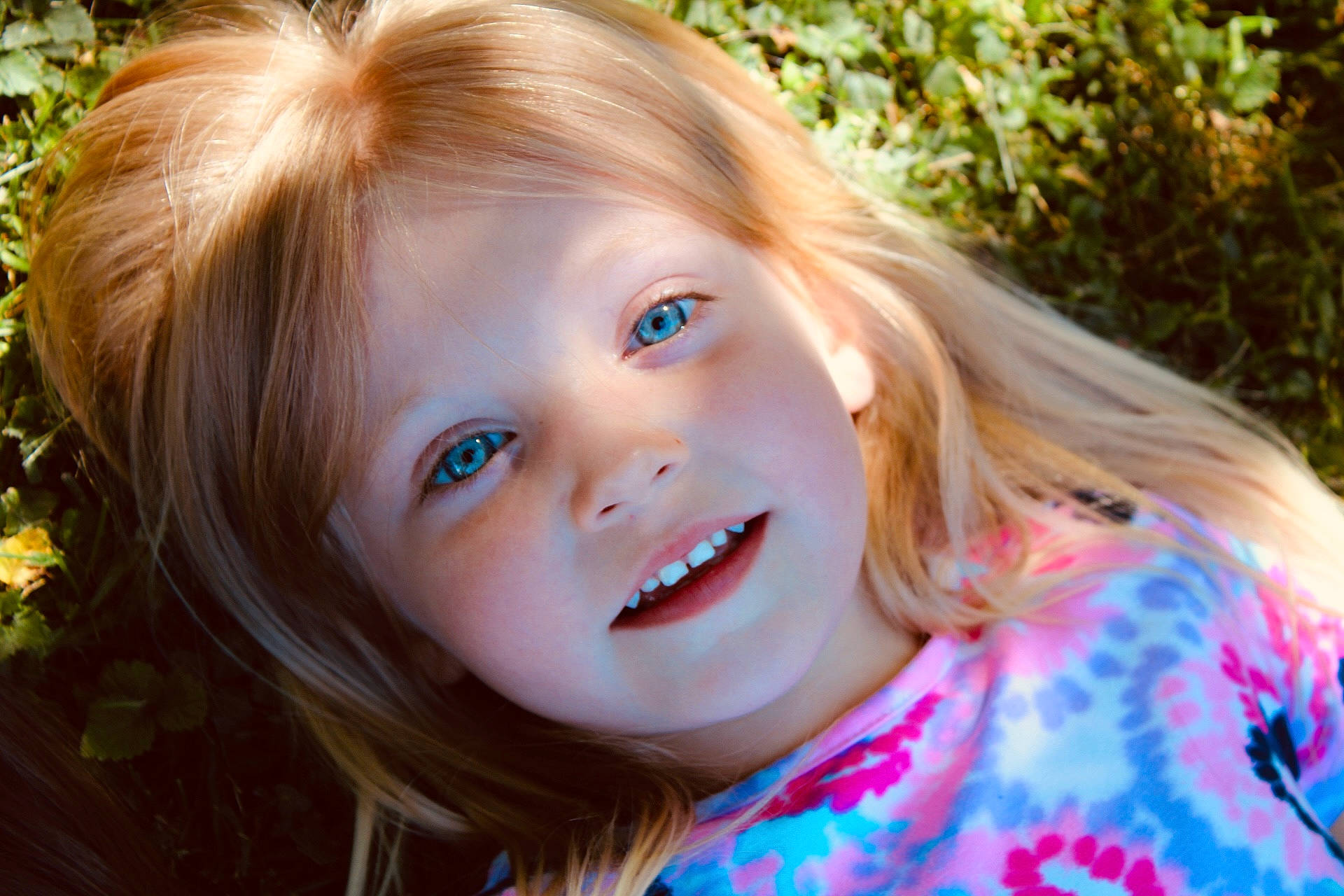 Emberlynn is registered to the contest to win money with this photo: cheek, chin, eye, eyelash, face, grass, happy, head, iris, leaf, lip, nature, nose, people_in_nature, person, plant, skin, smile, summer, sunlight
