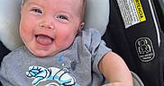 Saylor joined the competition — help win amazing prizes! baby, smiling, toddler, car_seat, astronaut_tshirt, happy, infant, outdoor, clothing, seat, child, cute, person, head, face, skin, expression, baby_girl, baby_boy, daylight