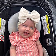 Saylor joined the competition — help win amazing prizes! baby, child, smiling, car_seat, bow, headband, pink_clothing, striped, infant, cute, happy, portrait, sitting, indoor, safety, car_seat_warning, clothing, person, young_child, infant_fashion