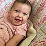 baby, smile, blanket, pink, happy, infant, face, child, seat, pattern, cozy, cute, indoor, wood, clothing, portrait, skin, eye, expression, comfort