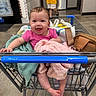 Saylor joined the competition — help win amazing prizes! baby, shopping_cart, blanket, bag, pink_shirt, smile, happy, infant, footwear, floor, person, clothing, indoor, supermarket, shopping, retail, store, child, toddler, cute