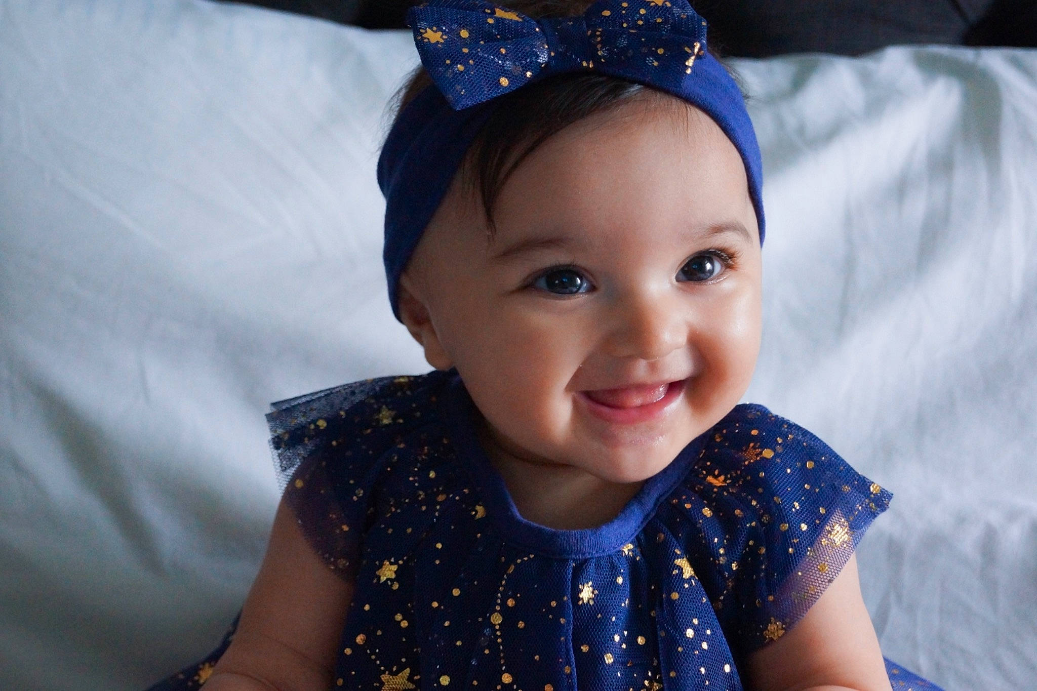 Sophia Grace is registered to the contest to win money with this photo: baby, blue, cheek, child, clothing, costume_accessory, ear, fashion_accessory, hair_accessory, head, headband, headgear, headpiece, iris, joy, lip, person, photography, skin, smile