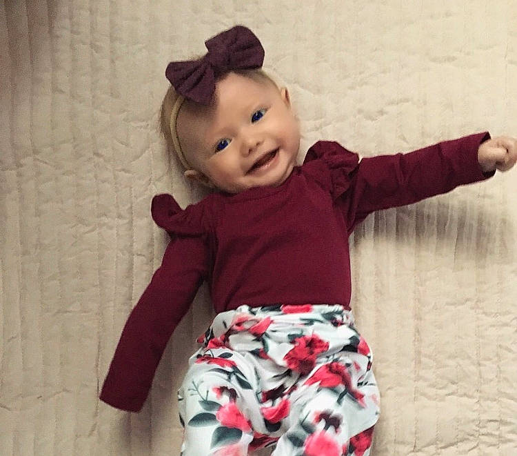 Juliette is registered to the contest to win money with this photo: arm, baby, baby_toddler_clothing, cheek, child, clothing, head, joint, joy, pattern, person, pink, product, shoulder, sleeve, smile, t_shirt, toddler