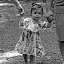 Trinity is registered to the contest to win money with this photo: child, toddler, barefoot, walking, holding_hands, floral_dress, outdoor, gravel_path, family, black_and_white, person, adult, nature, cute, happy, smiling, portrait, young_child, summer, foot