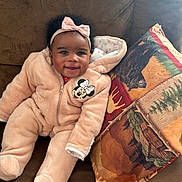 Dynasty Amour joined the competition — help win amazing prizes! baby, infant, smiling, pink_onesie, headband, bow, couch, pillow, brown_fabric, minnie_mouse, child, indoor, cozy, happy, cute, portrait, seated, plush_clothing, warm, comfortable
