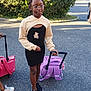 child, girl, glasses, braids, black_dress, teddy_bear_print, beige_hoodie, purple_backpack, rolling_luggage, asphalt, outdoor, sunlight, greenery, bushes, trees, person, shoes, sneakers, standing, travel