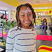 Jahlyss participe au concours pour gagner de l'argent avec cette photo : child, face_paint, smile, indoor, striped_sweater, girl, portrait, people, cafe, table, chair, colorful, decor, plants, lighting, hairstyle, young, happy, casual, photography