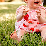 Ava is registered to the contest to win money with this photo: toddler, child, grass, outdoor, smiling, barefoot, curly_hair, pink_dress, strawberries, happy, sunlight, nature, baby, sitting, summer, cute, playful, portrait, joy, fun