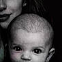 baby, infant, child, adult_partial, face, eyes, forehead, ear, nose, mouth, portrait, closeup, black_and_white, gaze, skin, head, hair, family, studio, candid