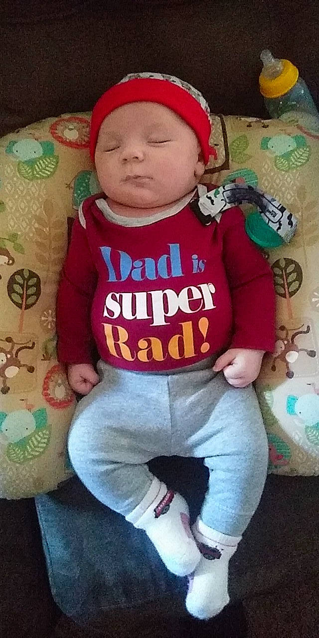 Terrance is registered to the contest to win money with this photo: baby_products, cap, cheek, child, cool, day, fun, headgear, infant, person, play, product, red, sitting, skin, smile, textile, toddler, toy