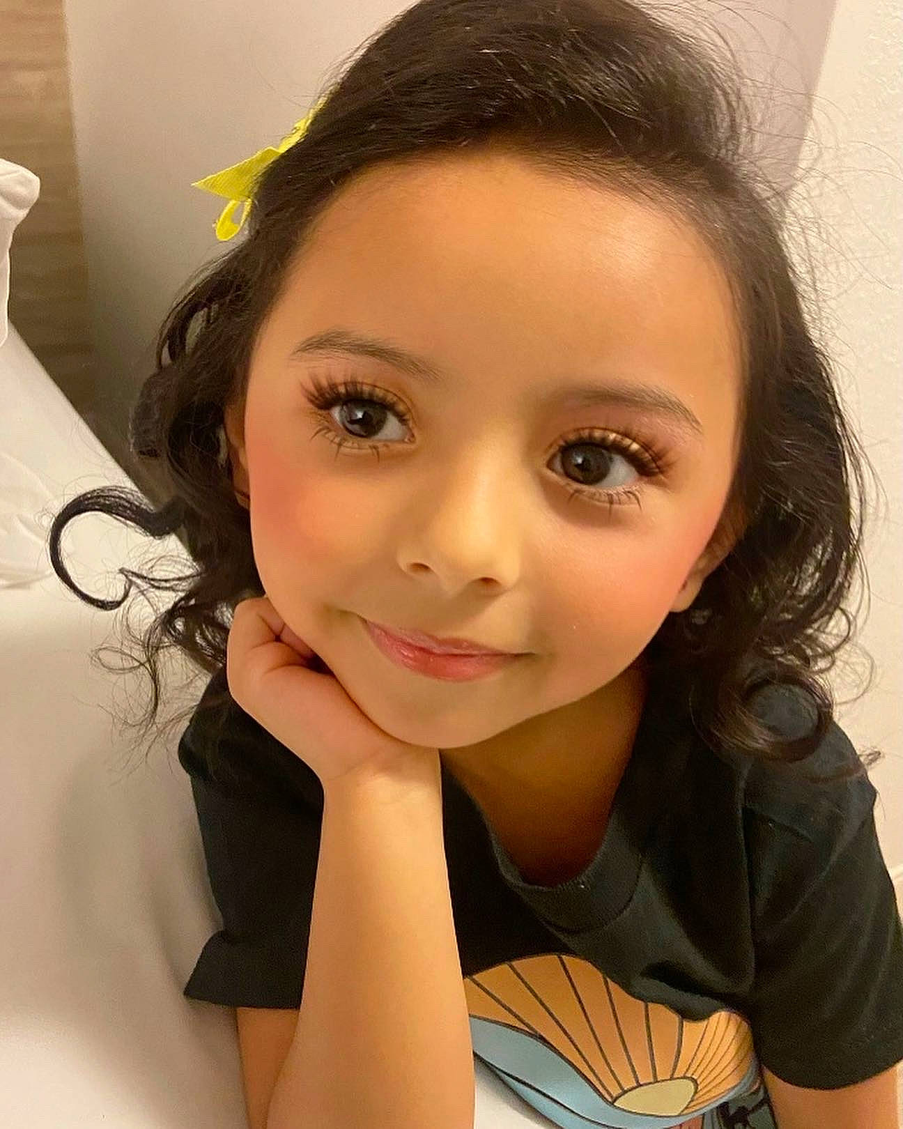 Isabella is registered to the contest to win money with this photo: arm, black_hair, cheek, chin, ear, eyebrow, eyelash, face, flash_photography, forehead, gesture, hairstyle, happy, iris, jaw, joy, lip, neck, nose, person