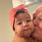 Lilith joined the competition — help win amazing prizes! baby, child, adult, kiss, affection, headband, pink, bow, closeup, face, cheeks, expression, indoor, mirror, love, person, clothing, pattern, cute, portrait