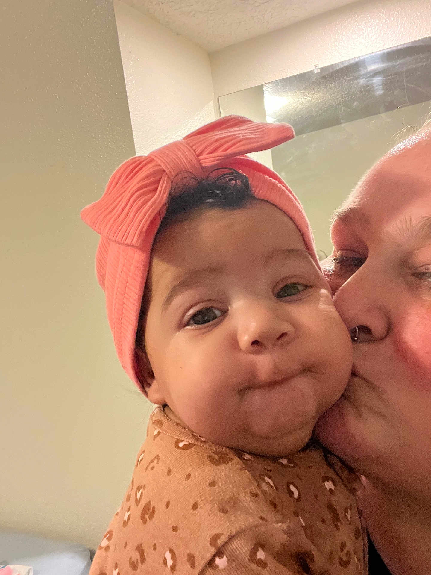 Lilith joined the competition — help win amazing prizes! baby, child, adult, kiss, affection, headband, pink, bow, closeup, face, cheeks, expression, indoor, mirror, love, person, clothing, pattern, cute, portrait