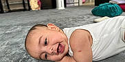 Habeebullah joined the competition — help win amazing prizes! baby, smiling, carpet, infant, lying_down, arm, scratch, white_clothing, indoor, home, floor, face, cheerful, child, person, soft_texture, cute, relaxed, head, closeup