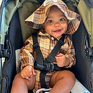 Elijah is registered to the contest to win money with this photo: accessories, baby, baseballcap, cap, clothing, coat, face, footwear, happy, hat, head, jacket, pants, person, photography, portrait, shoe, shorts, smile, stroller
