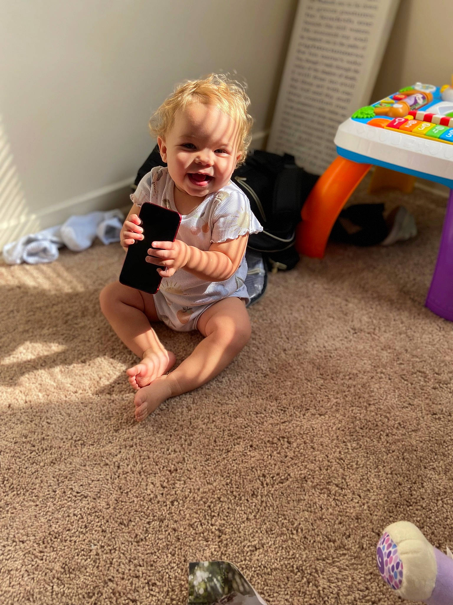 Jazzlynn is registered to the contest to win money with this photo: baby, baby_playing_with_toys, baby_toddler_clothing, barefoot, child, floor, flooring, foot, fun, hardwood, human_leg, person, play, product, room, sitting, smile, standing, toddler, toy