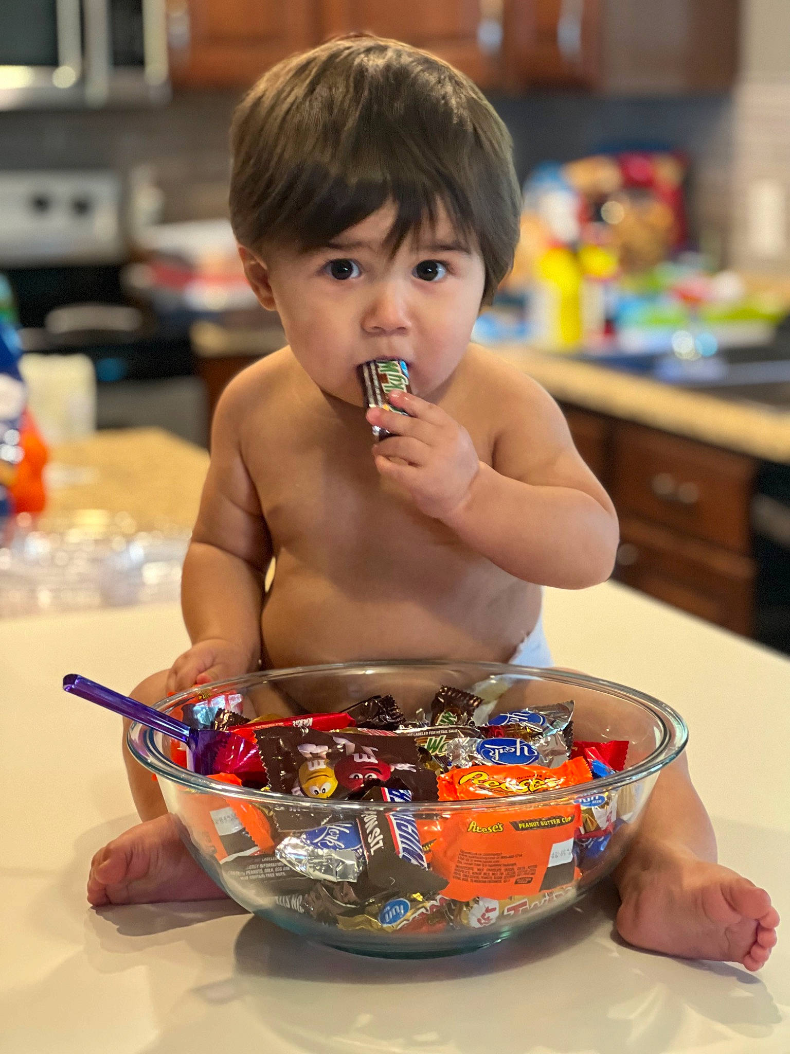 Wyatt is registered to the contest to win money with this photo: baby, cabinetry, chest, child, cuisine, cup, drawer, drinkware, eating, event, eyelash, food, fun, happy, head, junk_food, person, serveware, surprise, sweetness