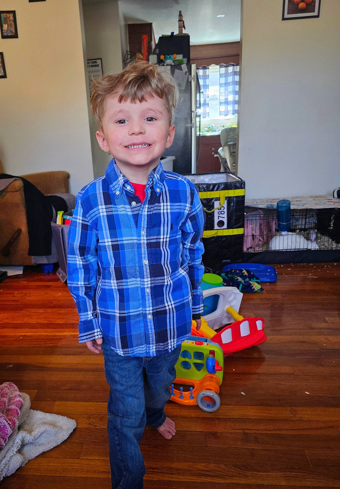 Bryson joined the competition — help win amazing prizes! architecture, boy, building, child, clothing, couch, face, furniture, hardwood, head, indoors, jeans, livingroom, male, pants, person, photography, portrait, shirt, wood