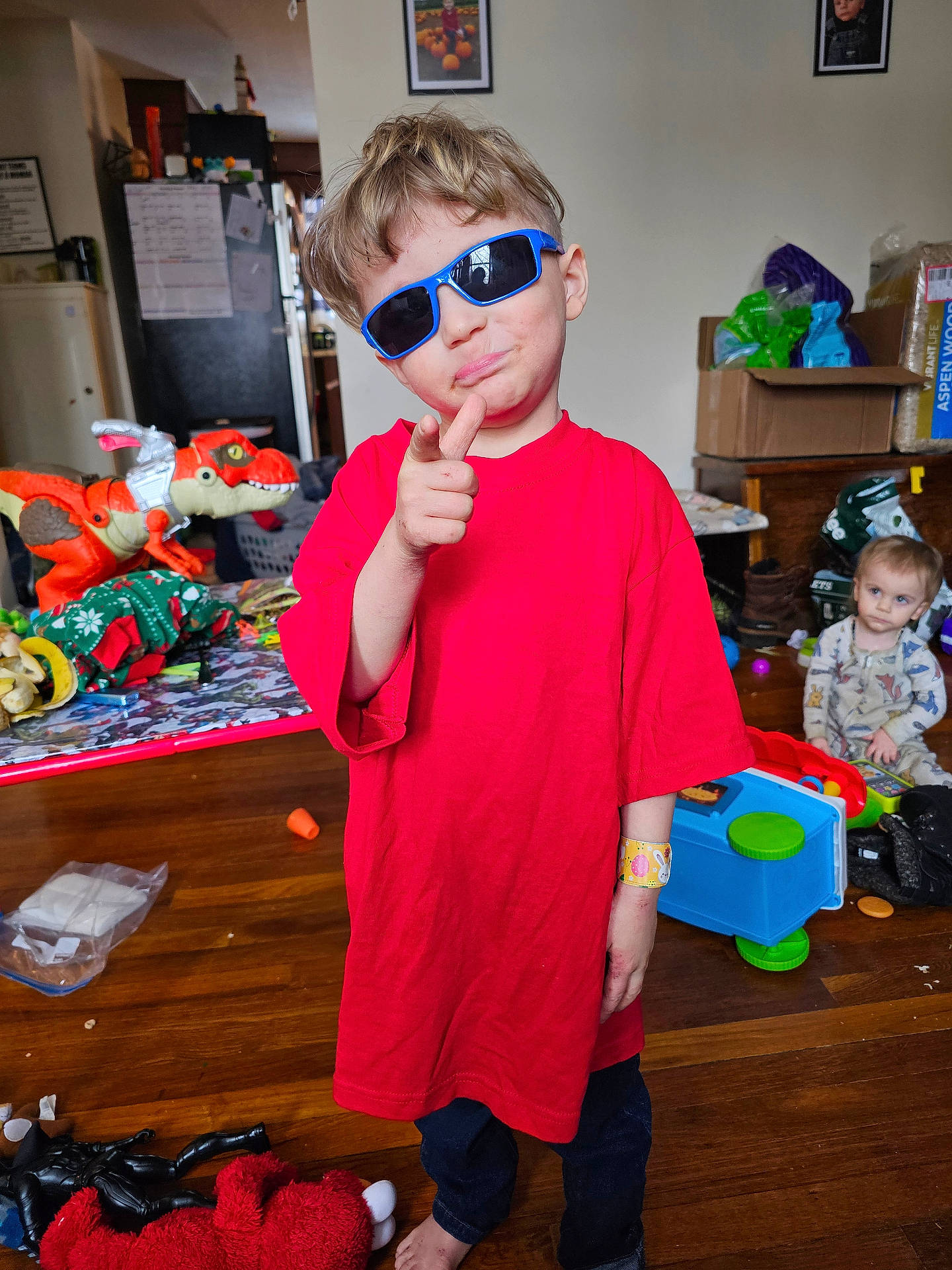 Bryson is registered to the contest to win money with this photo: accessories, baby, bodypart, box, boy, child, clothing, face, finger, footwear, hand, hardwood, head, male, person, photography, portrait, shoe, sunglasses, wood