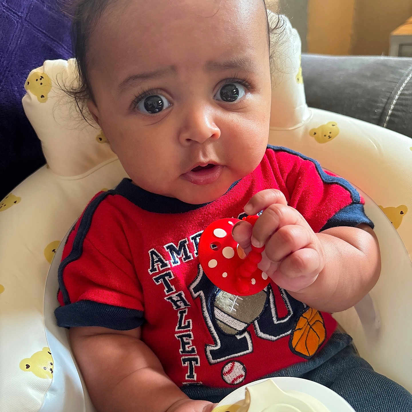 Carnell is registered to the contest to win money with this photo: baby, bodypart, clothing, couch, cushion, cutlery, face, finger, food, furniture, hand, head, homedecor, meal, person, photography, portrait, sitting, spoon, t_shirt