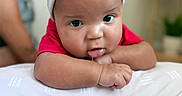 Reshard joined the competition — help win amazing prizes! baby, beanie, blurred_background, child, cozy, cute, drool, expression, face, hat, headwear, home, indoors, infant, person, red_shirt, resting, skin, soft_surface, young