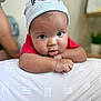 Reshard joined the competition — help win amazing prizes! baby, infant, beanie, hat, drool, face, cute, red_shirt, resting, soft_surface, indoors, blurred_background, child, young, person, skin, expression, headwear, cozy, home