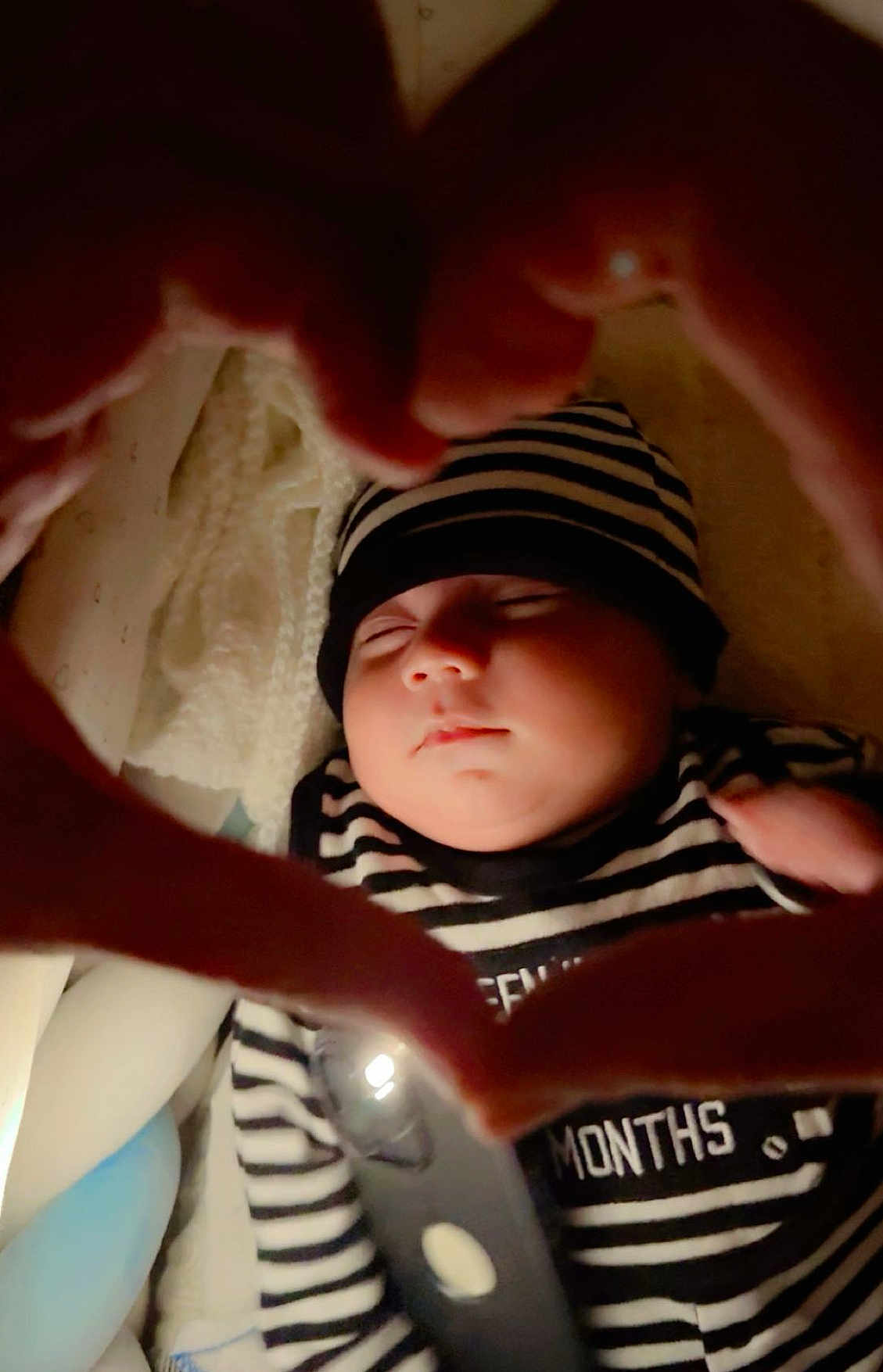 Muhammad Zaviyar is registered to the contest to win money with this photo: baby, sleeping, infant, striped_clothing, hat, hands, heart_shape, closeup, peaceful, soft_lighting, indoor, portrait, cute, toddler, newborn, child, cozy, warm, skin, face