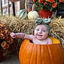 baby, pumpkin, headband, flower_pot, autumn, hay_bale, smile, cute, child, orange, seasonal, fall_decor, plant, outdoor, portrait, decoration, flower, festive, holiday, happy