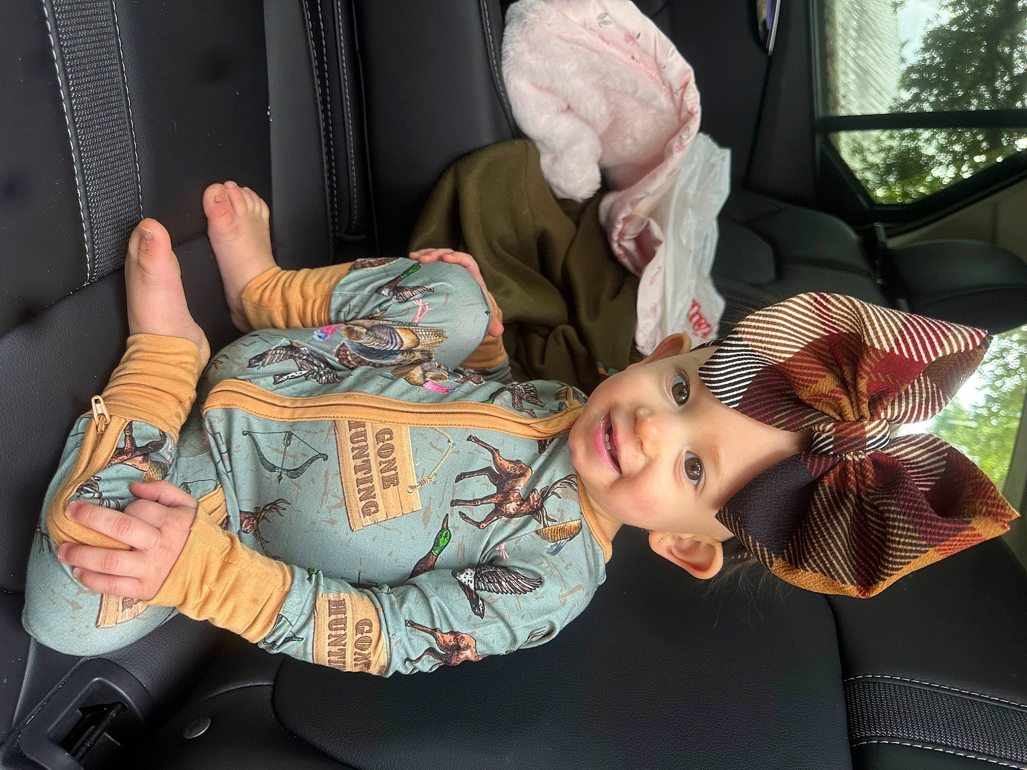Addison is registered to the contest to win money with this photo: auto_part, baby, car_seat, child, comfort, cool, elbow, finger, flesh, fun, gesture, hat, joy, person, sitting, sun_hat, thumb, toddler, toy, tree