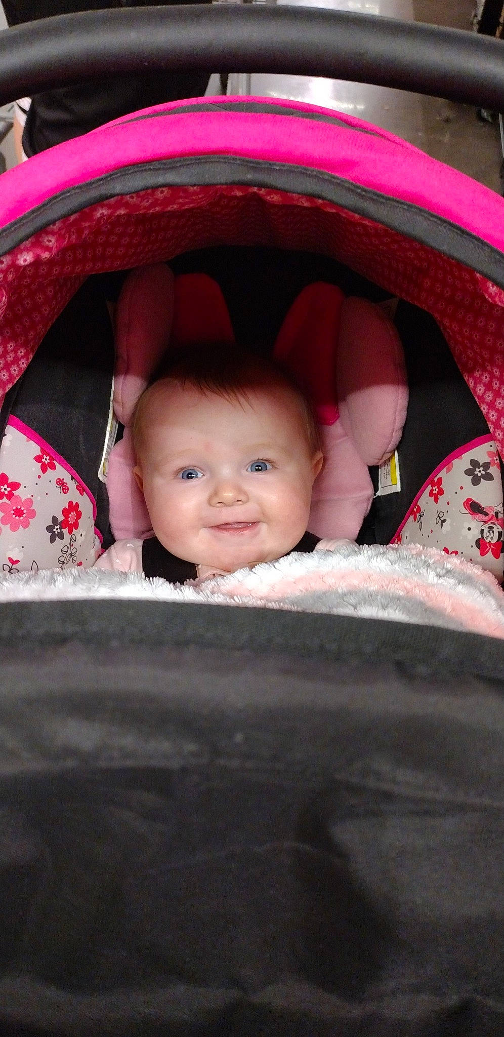 Liliana is registered to the contest to win money with this photo: baby, baby_carriage, chin, eye, eyebrow, flash_photography, hairstyle, happy, head, human_body, iris, joy, lip, motor_vehicle, mouth, person, pink, product, red, skin