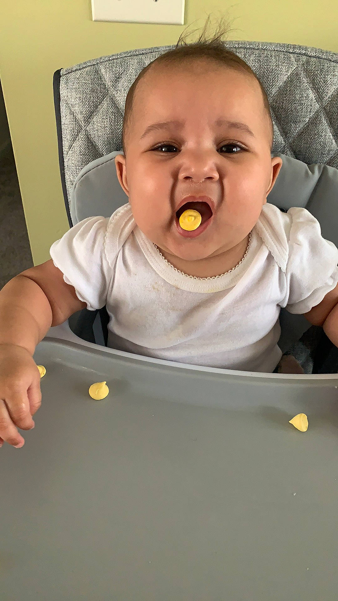 Jacquelyn is registered to the contest to win money with this photo: baby, baby_products, baby_toddler_clothing, chair, cheek, child, comfort, eating, fun, happy, head, mouth, nose, person, product, room, sitting, sleeve, table, tableware