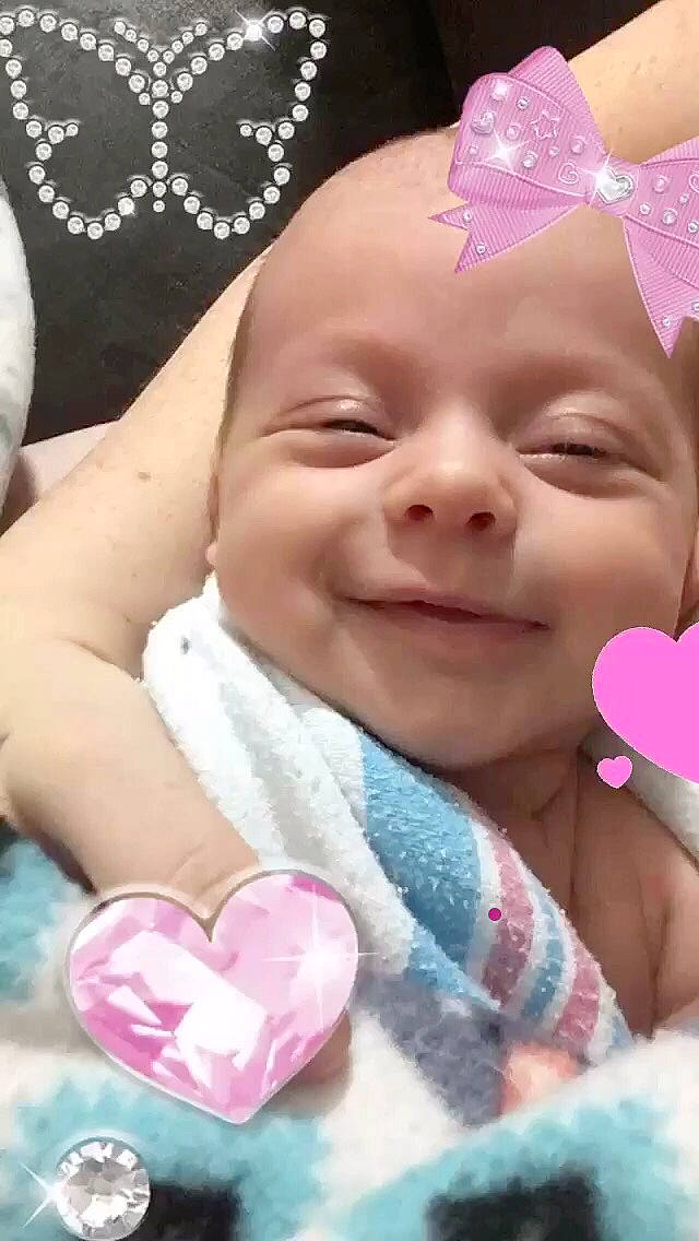 Noel is registered to the contest to win money with this photo: baby, baby_laughing, baby_making_funny_faces, birth, cheek, child, face, hair_accessory, happy, head, joy, lip, mouth, nose, person, pink, skin, smile, toddler